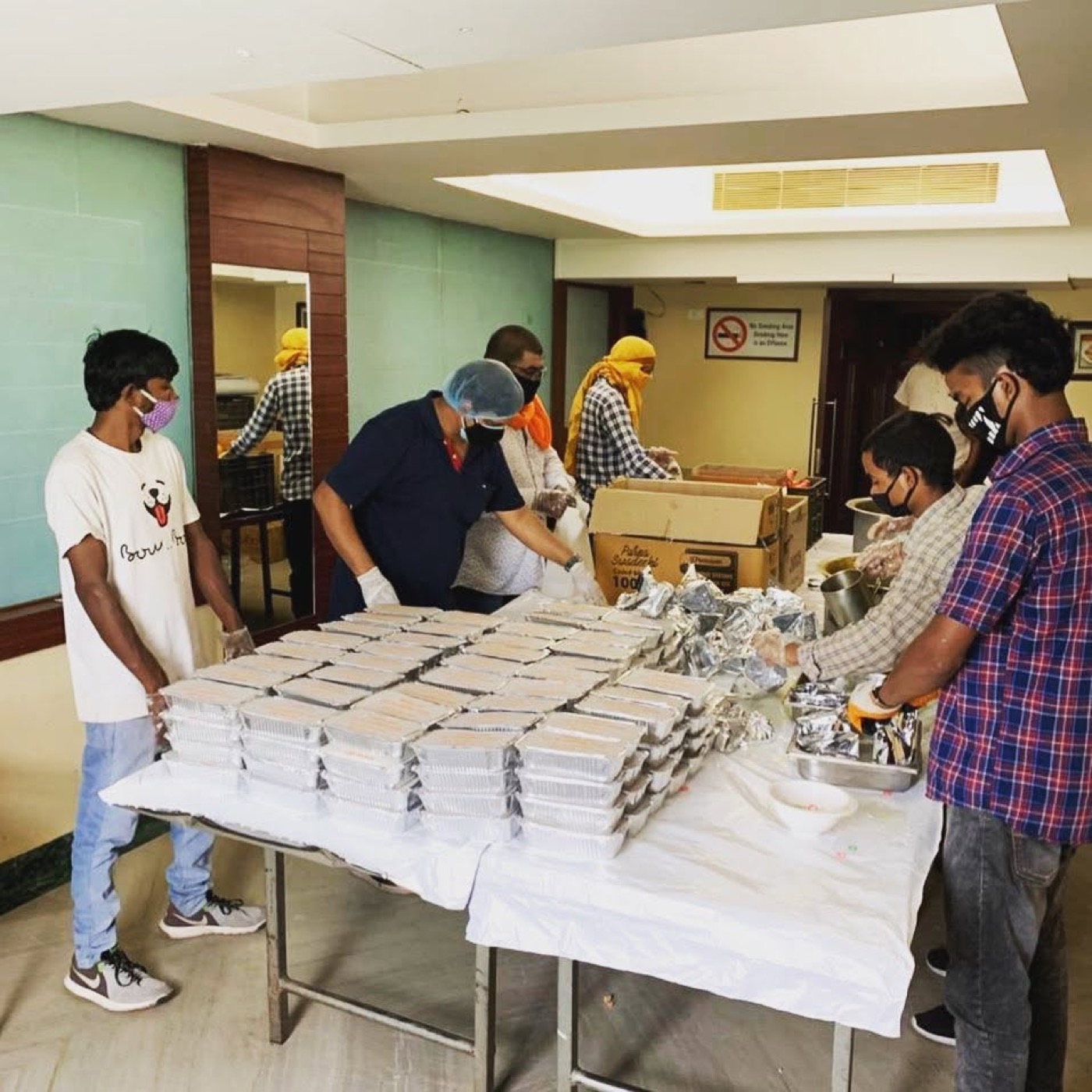 Volunteers preparing food packets for distribution
