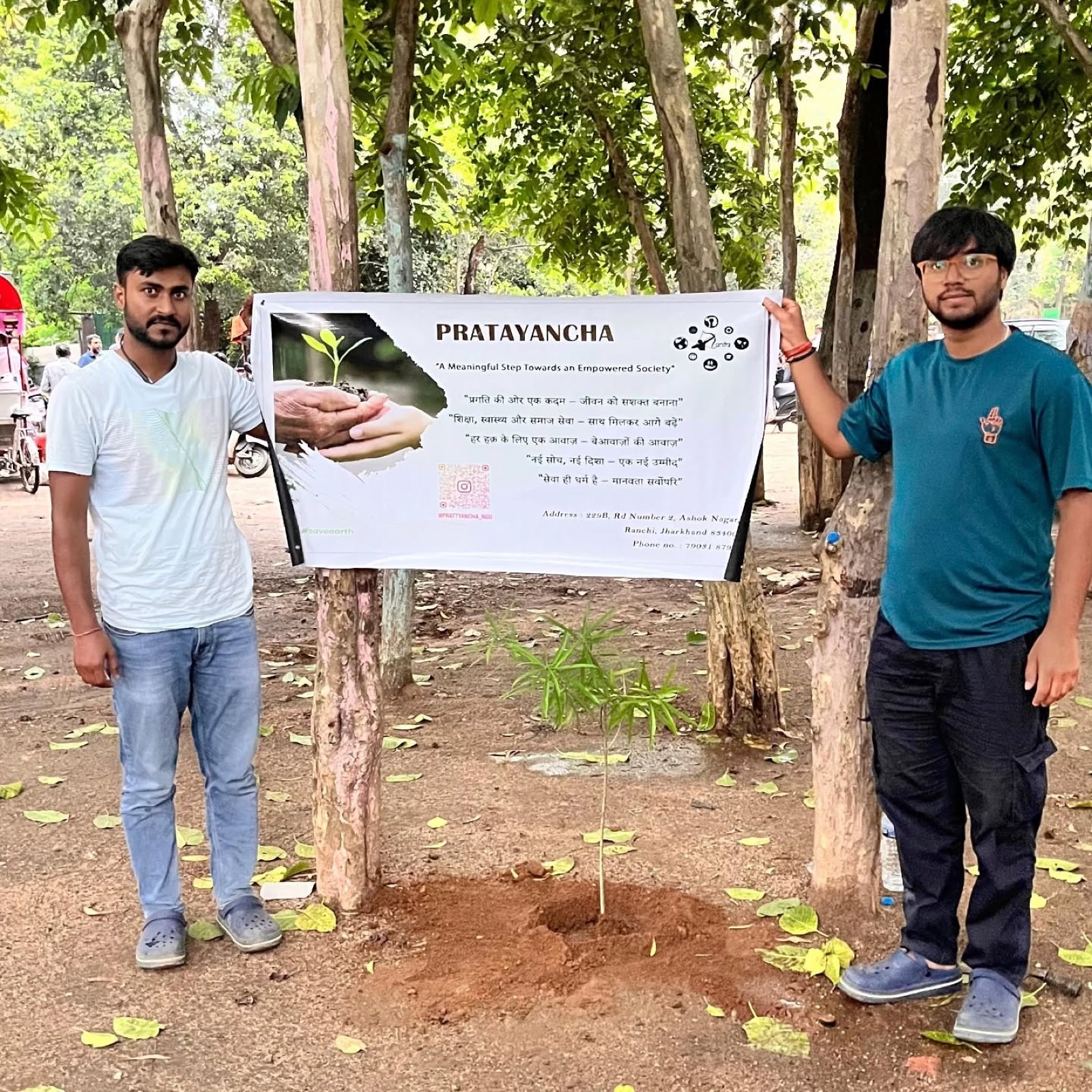 Prattyancha tree plantation drive with volunteers holding a banner
